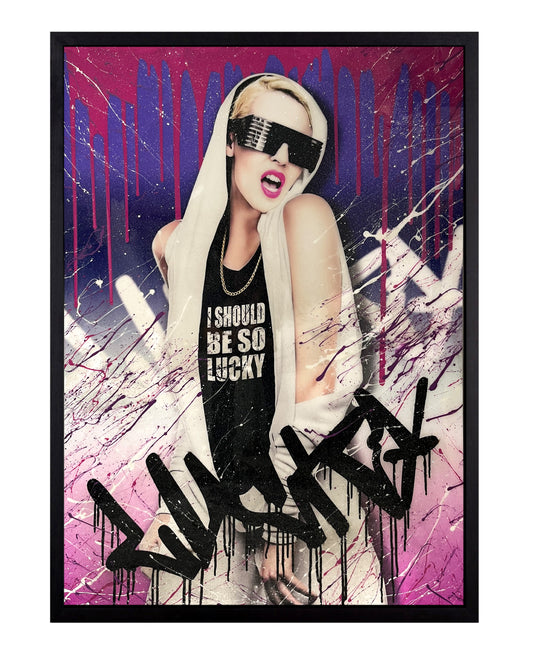 Kylie Minogue artwork with purple, navy, and pink gradient colors, inspired by an '80s futuristic vibe. Features the word 'Lucky' spray-painted, with mixed media elements including glitter resin and splattered acrylic paints for a bold, dynamic design.