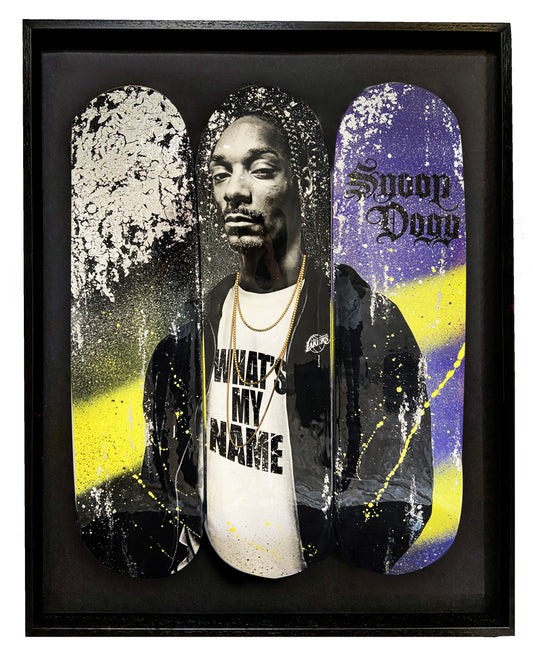 Snoop Dogg skateboard deck featuring purple and yellow spray paints with glitter resin for a bold, eye-catching design. Skateboard art.